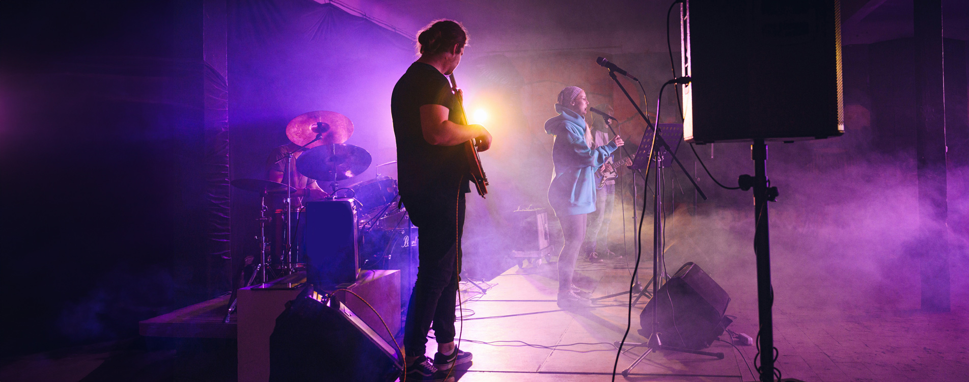 Live band performing under purple stage lights at The Maddox Hotel